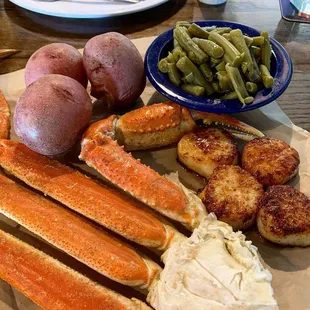 Combo platter with snow crab legs, pan seared scallops, new potatoes and green beans.