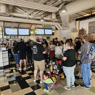 a large group of people waiting in line