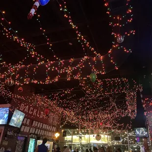 Holiday lights strung all across the ceiling, giving it a fun vibe