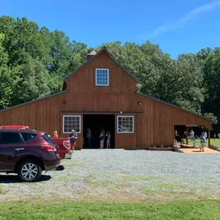 a car parked in front of a barn