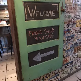 a green door with a welcome sign
