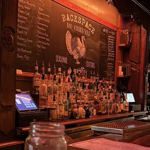 a chalkboard with a lot of bottles on it