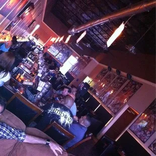 a woman sitting on a couch in a bar