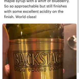 a person holding a bottle of wine