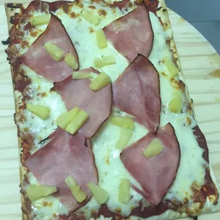 ham, pineapples, and cheese pizza