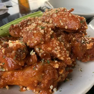a plate of chicken wings and celery