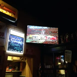 a large television screen above the bar