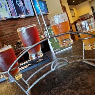 a row of beers on a bar