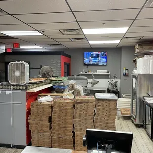Pizza kitchen is busy, cluttered, but clean and efficient