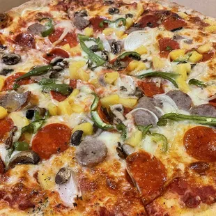 A supreme 16&quot; pizza with olives on the side and pineapple on top (extra $3)