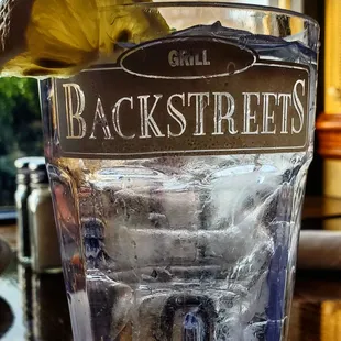a glass of water with a lemon wedge