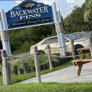 a car parked in front of a sign