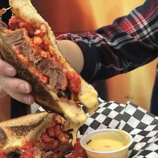 a person holding a half eaten sandwich