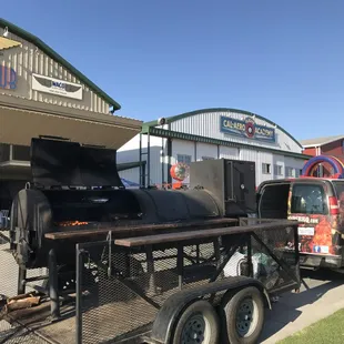 a truck pulling a bbq on a trailer