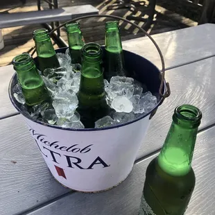 a bucket full of beer bottles and ice