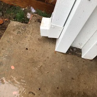 Downspout drains onto patio.