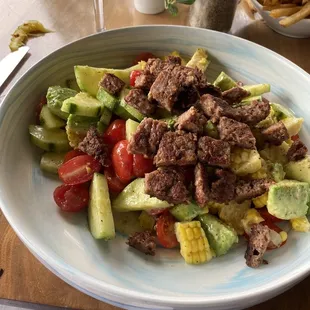 Avocado, corn &amp; tomato salad. Added impossible patty. It&apos;s vegan!