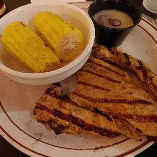 Grilled chicken breast and mushroom truffle gravy with a side of grilled corn.