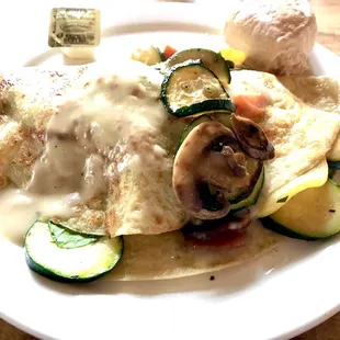 Vegetable crepe with a cream sauce and a roll. A filling but light meal.
