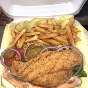 Catfish poboy. Smells and taste good. 1 filet vs 2 on the platter plus coleslaw/fries/toast for same price. You decide.