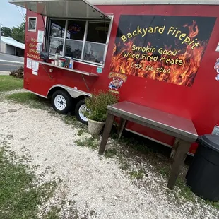 a red food truck parked on the side of the road