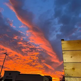 a sunset over a parking lot
