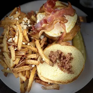 Ground Chuck Sandwich with Bacon and Cheese. Sliced Potatoes on the side and a pickled cuke umber.