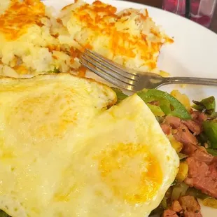 Corned beef hash over med egg.