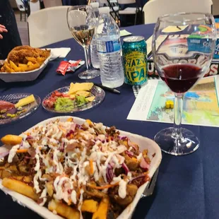 a plate of fries and a glass of wine