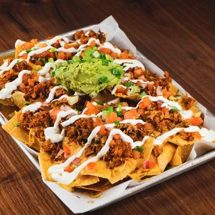 a plate of nachos with guacamole