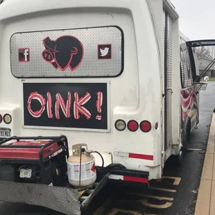 the back end of a white bus