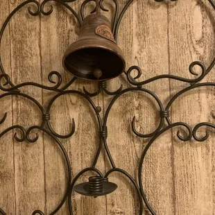 a wall decoration with a bell