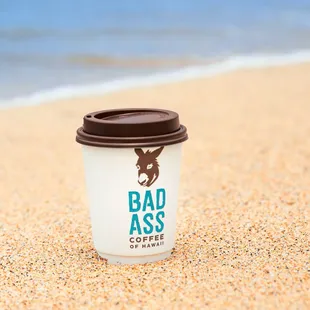 a coffee cup on the beach