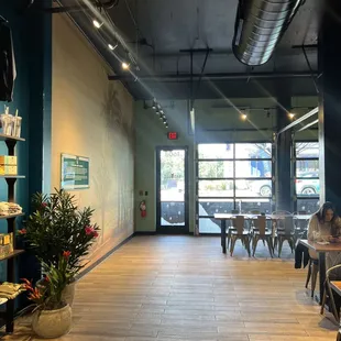 a woman sitting at a table in a coffee shop