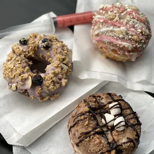 three doughnuts on wax paper