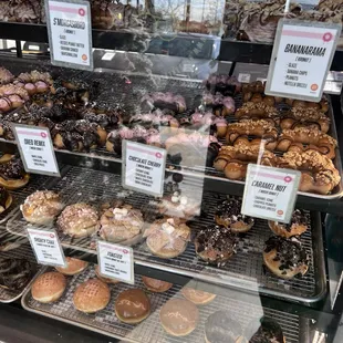a variety of donuts in a display case