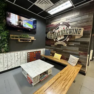 a wooden bench with a tv in the background