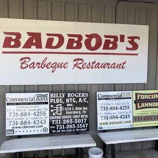 two benches and a sign