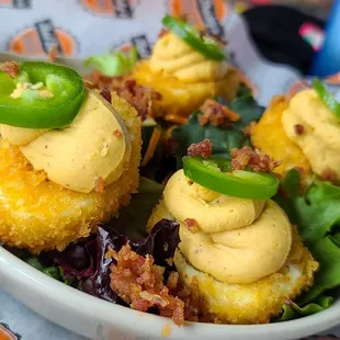 Crispy Deviled Eggs - lightly fried, topped with smoked paprika + bacon candy!