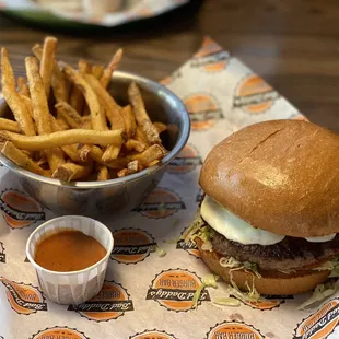 Thick burger with mozzarella, fries with spicy dipping sauce.