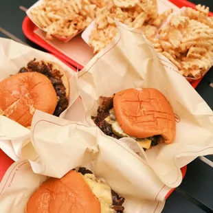 a tray of hamburgers and fries