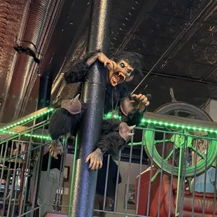 a fake monkey hanging from a pole