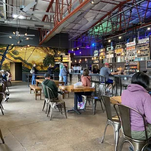people sitting at tables in a restaurant