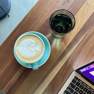 a cup of coffee and a laptop
