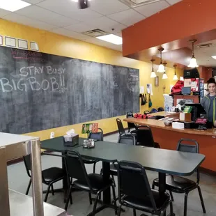 two people standing in front of a blackboard