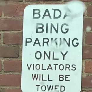 a sign on a brick wall
