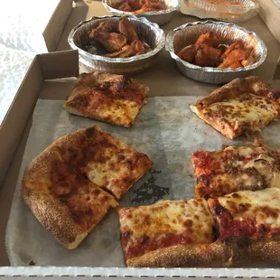 Sausage and onion pizza, spicy garlic wings, Cajun wings, hot sauce.