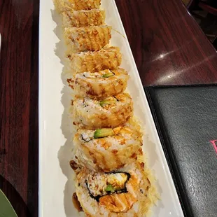 a long plate of sushi rolls
