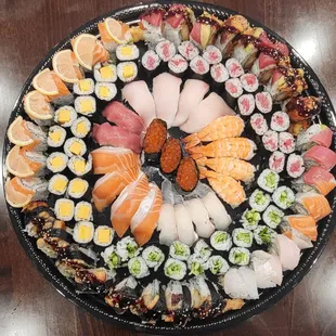 a platter of different types of sushi