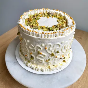 Shrikhand Cake- a traditional Indian dessert turned into a cake! Fluffy cardamom cake with saffron cream cheese frosting between the layers.